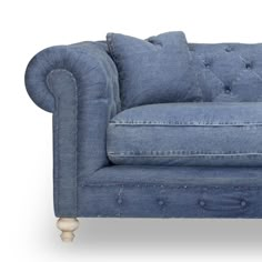 a blue couch sitting on top of a white floor