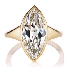 3.84 carat Marquise Cut Diamond in 18kt Yellow Gold Setting The Marvella 3.84 ring is an AB original design made right here in NYC. The ring centers a GIA-certified 3.84-carat Marquise cut diamond of M color, VVS2 clarity. The stone is bezel set in an 18kt yellow gold setting. The ring is currently sized slightly over Settings For Marquise Diamonds, Exquisite Gold Marquise Cut Ring, Gold Marquise Cut Hallmarked Diamond Ring, Luxury Marquise Yellow Gold Diamond Ring, 14k Gold Marquise Diamond Ring Hallmarked, Luxury Marquise Yellow Gold Rings, Marquise Cut Diamond Engagement Rings, Marquis Diamond, Victor Barbone Jewelry