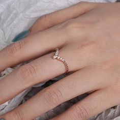 a woman's hand with a diamond ring on top of her finger and the other hand