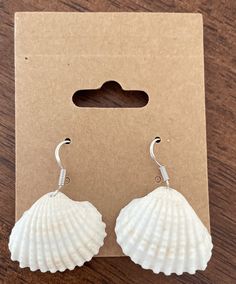 These handmade sea shell earring are perfect for beach lovers.  They are delicate dangle silver earrings. Great as a gift for loved ones. Handmade Beachy Earrings As Gift, Handmade Beachy Earrings For Gift, Beachy Shell Dangle Earrings, Summer Gift Shell-shaped Earrings, Shell-shaped Sterling Silver Jewelry For Beach, Ocean-inspired White Sterling Silver Jewelry, Ocean-inspired Shell Earrings With Ear Wire, Adjustable Shell Earrings With Ocean-inspired Style, Adjustable Shell Earrings, Ocean-inspired