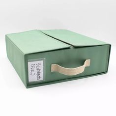 a green box with a ribbon on it