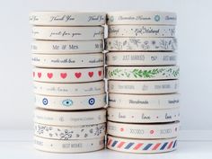 a stack of white washi tapes with hearts and flowers on them, stacked next to each other