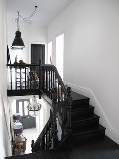 a black and white staircase leading up to the second floor