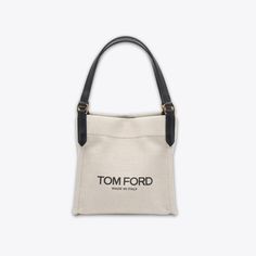 Carry your essentials in style with the Amalfi Small Canvas Tote Bag. From the Amalfi Collection by TOM FORD, this bag is made of durable canvas and features logo lettering for a chic touch. Perfect for everyday use, it's a practical and fashionable choice. Chic Coated Canvas Bag For Travel, Luxury Canvas Bucket Bag For Everyday Use, Tan Bucket Bag With Dust Bag For Daily Use, Classic Tan Bags With Logo, Chic Coated Canvas Bag With Removable Pouch, Modern Tan Bags For On-the-go, Canvas Pouch Shoulder Bag For Shopping, Modern Canvas Bags For Shopping, Modern Tan Bucket Bag For Travel