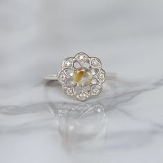 Sometimes when a girl says she likes to receive flowers as a gift, it's not the real flowers she means. Think twice and go for the safest thing - our Flora ring with Golden Rutile Ring with Moissanite. Floral jewelry is where it's at! Perfect as a graduation gift, birthday gift, anniversary ring, or a promise ring. Det Rose Cut Diamond Flower Promise Ring, Heirloom Flower Ring With Rose Cut Diamonds As Gift, White Rose Cut Diamond Flower Ring For Anniversary, Heirloom Rose Cut Diamond Flower Ring As Gift, Diamond White Sterling Silver Flower Ring, Sterling Silver Flower Ring In Diamond White, Flower Ring With Rose Cut Diamonds For Gifts, Diamond White Flower Ring For Gift, Diamond Flower Ring With Birthstone For Promise