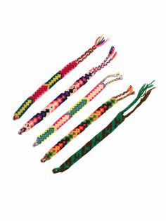 four different colored braided bracelets on a white background