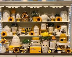 sunflowers and bee themed dishes are on display