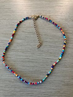 This is a super cute every day seed bead necklace to pair with any outfit! This has multiple different colors and includes extension chain for multiple sizes. Multicolor Heishi Beads Necklace With Tiny Beads, Colorful Heishi Beads Choker Necklace, Trendy Colorful Beaded Necklaces With Tiny Beads, Colorful Trendy Beaded Necklaces With Tiny Beads, Trendy Rainbow Beaded Necklaces, Trendy Rainbow Beaded Necklace, Trendy Colorful Beaded Necklaces With Letter Beads, Trendy Colorful Beaded Necklace With Letter Beads, Trendy Tiny Beads Necklace For Jewelry Making