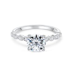 a white gold engagement ring with an oval cut diamond surrounded by pave set diamonds