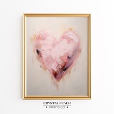 a pink heart painting hanging on the wall in a gold frame with text crystal peach prints co