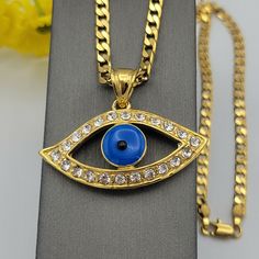 GOLD PLATED JEWELRY Blue Evil Eye Protection Necklace. 24K Gold Plated The evil eye is commonly used as an amulet or talisman in order to cleanse curses away. It is a common belief in most cultures. If you wear the evil eye figure in talismans, symbols and jewelry, you’re supposedly shielding yourself from greater doom. PENDANT Material: 24K Gold Plated over environmental copper Size: 1.75" W x 1.25" H (Including Bail) *Size Reference: A Quarter Coin is 0.95in / almost 1 inch* CHAIN Material: 24K Gold Plated over environmental copper Size: 18 inches - 4mm We seek to do the best in our work, if there is any problem, please let us know to fix it ASAP. God bless you! U.S. Seller:  Shipping with tracking number. Evil Eye Crystal, Evil Eye Protection, Crystal Pendant Necklace, Protection Necklace, Jewelry Blue, Blue Evil Eye, Crystal Necklace Pendant, Eye Protection, Fashion Jewelry Necklaces