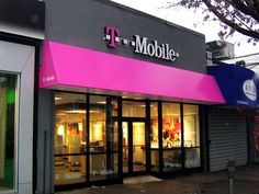 a t - mobile store on the corner of a street