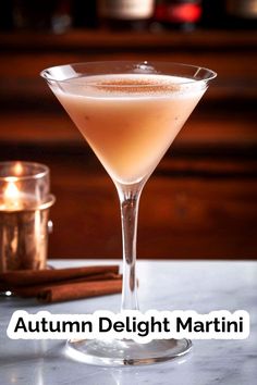 an autumn delight martini is served in a coupe glass with cinnamon garnish on the rim