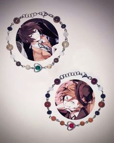 two necklaces with anime characters on them