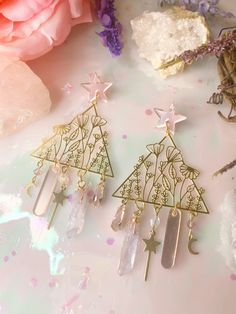 these earrings are fit for a fairy 🧚 though they do feature multiple cute charms, they are super lightweight!  attached to silver plated nickel free earring studs all jewelry in my shop is hand made by myself, so no two pieces will ever be the same. when i restock multiple of a design, keep in mind that things like crystals may vary in shape/size. 💕 Cute Charm Earrings For Gifts, Charm Dangle Earrings For Gifts, Bohemian Dangle Clip-on Earrings As Gift, Handmade Fairycore Dangle Earrings, Handmade Fairycore Drop Earrings, Handmade Dangle Earrings In Fairycore Style, Whimsical Nickel Free Dangle Flower Earrings, Whimsical Nickel-free Flower Earrings For Gifts, Whimsical Nickel-free Flower Earrings As Gift