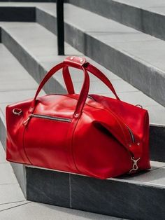 Our leather duffle bags are the perfect weekend bags to carry for both function and style. Large, sustainable and timeless good – bought once and for all! Several meters of genuine red leather turned into a modern travel bag handcrafted individually for you! Short trips or long-term voyages, business assignments and round-the-city walks, there isn’t a situation where this large bag will let you down. Red Travel Bag With Leather Handles, Red Rectangular Duffle Bag With Zipper Closure, Red Rectangular Duffle Bag For Daily Use, Red Duffle Bag Tote For Everyday Use, Red Tote Duffle Bag For Travel, Red Rectangular Bag For Weekend Trips, Red Tote Duffle Bag For Everyday Use, Red Rectangular Travel Bag With Zipper, Red Leather Travel Satchel