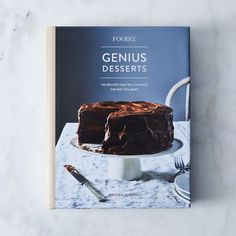 a cookbook about genius desserts sits on a table