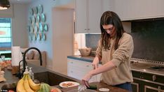 a woman is preparing food in the kitchen