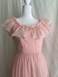 "This petite ruffled Prarie style bridesmaid dress was worn once for a wedding in 1981. It is in good vintage condition with two stains (pictured), a loose hem, and a few stray threads in the lining. There are belt loops sewn onto the waist, but the grosgrain ribbon is missing.  Measurements: Bust, taken flat PTP: 16\" Waist, taken flat: 11.5\" Hip, taken flat: 21.5\" Length, center of neckline to bottom of hem: 49\"" 1950s Vintage Ruffled Dress For Summer, 1950s Vintage Summer Dress With Ruffles, 1950s Style Vintage Ruffled Dress For Summer, Vintage Sleeveless Bridesmaid Dresses, Elegant Vintage Ruffled Dress For Prom, 1950s Ruffled Vintage Dress For Spring, Vintage Party Dress With Ruffle Hem, Spring Wedding Vintage Dress With Ruffles, Fitted Ruffle Vintage Dress For Prom