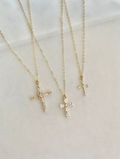 Stunning Pave Cubic Zirconia cross necklaces.  Take your pick. Gorgeous gift necklace, baptism or dedication gift.  Beautiful bridal necklaces too.   - Pendants - CZ + 14k gold plated brass - tarnish resistant - Chain + components - 14K Gold-filled  - Lobster Clasp - 14K Gold-filled   Cross #1 - 20mm x 27mm Cross #2 - 11mm x 16mm Cross #3 - 11mm x 14mm Listing is for one cross.  Choose from the pulldown menu. . . . . . . . . . . . . . . . . . . . . . . . . . . . . . . . . . .  Necklace arrives p Delicate Cross Jewelry For Wedding, Cubic Zirconia Crucifix Necklace For Gift, Dainty Cross Necklace For Baptism, Dainty Cross Pendant Necklace For Baptism, Delicate Cross Necklaces For Weddings, Dainty Gold Cross Necklace For Baptism, Dainty Cross Necklace For First Communion, Delicate Cross Necklace For Wedding, Dainty Cross Pendant Jewelry For First Communion