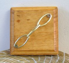 a pair of scissors sitting on top of a wooden box