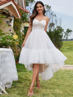 This wedding dress adopts an exquisite suspender design, with a charming sweetheart neckline, and a corset top design on the upper body to make the dress fit more closely to your body shape, making you feel confident at the wedding. Fit: Please refer to size chart. Length: High-Low. Sleeve Style: Sleeveless. Closure: It is concealed a zipper up the back. Undergarments: It is padded, with lining. Fabric:The garment comprises tulle. Stretch: Fabric is no stretch. Tulle Wedding Dress Short, Redprom Dresses, Wedding Parasol, Tulle Corset, Parasol Wedding, Maxi Dresses Formal, Wedding Dresses High Low, Chic Jumpsuit, Perfect Curves