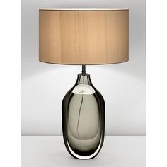 a table lamp with a shade on it and a white light in the corner next to it