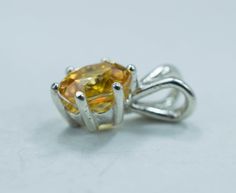 This is a beautiful natural and untreated Yellow Zircon from Madagascar set in Sterling Silver. This amazing stone has a great shade of golden/yellow that is very sought after and not easily found as well as a stunning cut which makes this Zircon really shine with an amazing luster and the best clarity! You will not be disappointed with this beautiful pendant! Zircon not to be confused with Cubic Zirconia is a natural gemstone and one of the oldest known materials on the planet! It also is one o Yellow Oval Citrine Jewelry, Oval Yellow Citrine Gemstones, Yellow Citrine Round Gemstones, Citrine Gemstone Jewelry With Round Cut, Yellow Oval Faceted Jewelry, Round Yellow Citrine Gemstones, Round Cut Citrine Gemstone Jewelry, Polished Yellow Citrine Jewelry, Faceted Yellow Citrine Gemstones