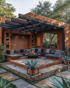 an outdoor living area with couches and potted plants