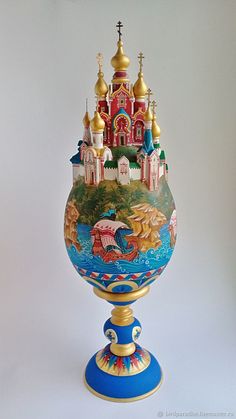 an ornate vase with a castle painted on it