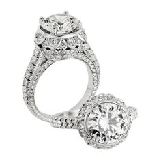 two engagement rings with diamonds on each side and an oval center stone in the middle