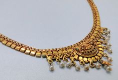 "22 k solid gold and pearl beads necklace choker from rajasthan india. detailed handcrafted, great piece for any collection. total length-15\"(we can adjust length), width of center-2.4 cm(inc. dangles), weight-17 grams. material-solid 22 k gold." Navratri 22k Gold Kundan Necklace, Traditional 22k Gold Pearl Necklace For Festive Occasions, Gold Pearl Necklace With Latkans Temple Style, 22k Gold Pearl Necklace For Diwali, Gold Bollywood Pearl Necklace For Festive Occasions, Gold Chandbali Pearl Necklace For Puja, Heavy Gold Pearl Necklace For Diwali, Traditional Gold Pearl Necklace For Puja, Festive 22k Gold Pearl Necklace