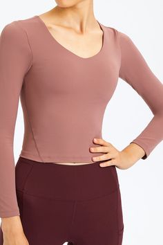 Sizing: Slim fit Pattern: Solid Features: Long sleeve. removable bra pads. fitness wear Necline: Round neck Sheer: No Stretch: Highly stretchy Product measurements: 4: length 17 in. bust 28 in. hem 26 in. sleeve 21 in6: length 18 in. bust 30 in. hem 27 in. sleeve 22 in8: length 18 in. bust 31 in. hem 29 in. sleeve 22 in10: length 19 in. bust 33 in. hem 30 in. sleeve 22 in12: length 19 in. bust 35 in. hem 32 in. sleeve 23 in Material composition: 80% nylon. 20% spandex Care: Machine wash cold. Tumble dry low. Imported Shipping time: 5-10 business days Versatile Breathable Tops, Versatile Breathable Elastane Tops, Breathable Elastane Tops, V-neck Elastane Activewear For Workout, Casual Elastane Tops For Pilates, Seamless Long Sleeve Activewear For Gym, Stretch Elastane V-neck Activewear, Fitted V-neck Crop Top For Workout, Sports Tops With Built-in Bra