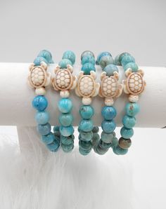 "Adorable turtle stretch bracelet with a white howlite 3/4\" x 1/2\" turtle and 8mm blue smooth round turquoise jasper beads. So cute on the wrist, wear alone or stack with other bracelets. Bracelet comes in a cute decorative pouch, great for gift giving. HOW TO WEAR STRETCH BRACELETS:  Cup your hand and roll bracelet over the hand up to the wrist. TO REMOVE STRETCH BRACELET:  Cup your hand and roll bracelet from the wrist down over the hand" Turtle Beaded Bracelets, Ocean Bracelet, Preppy Bracelets, Beachy Jewelry, Turtle Bracelet, Pretty Jewelry Necklaces, Bead Charms Diy, Ocean Jewelry, Beaded Jewelry Designs