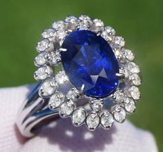 A Breathtakingly Striking HANDMADE 14k White Gold Ring with Beautiful Oval Cut Sapphire in Blue color! The GEM is 3.31CT and measures 10.05x7.23x5.77 mm! This Stone will take your breath away, especially on the sunlight! You will want to look at this stone endlessly. The mounting is a masterpiece! HANDMADE 14K White Gold Diamond Mounting (tested), that was is custom made to Accommodate this Beauty of a Gem in a V-prongs setting! Super FINE Workmanship on the Diamond v-split setting with 32 pcs Brilliant Full Cut Diamonds in GH color, SI1 clarity, totaling to approx  0.49CT ! Fabulous Braided Band and Diamond Gallery! The Entire Top's outline is 17.3x14.7 mm- HUGE. The Ring weights 6.4 g, nice and SOLID. Sits 8.6 mm off the top of the finger. Finger size 7(Free Re-sizing with purchase). Cen Exquisite Oval Platinum Gemstones, Exquisite Oval Brilliant Cut Gemstones, Exquisite Oval Brilliant-cut Gemstones, Luxury Oval Platinum Gemstones, Oval Sapphire Ring Gia Certified, Gia Certified Sapphire Cluster Jewelry, Gia Certified Oval Gemstones For Fine Jewelry, Luxury Oval Sapphire Gemstones, Blue Oval Sapphire Ring With Vvs Clarity