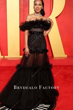 Kerry Washington dazzled at the 2024 Oscars After Party in a striking black gown with a sheer tulle skirt that cascades to the floor. The off-the-shoulder design features a ruffled neckline, and the bodice is adorned with sparkling embellishments, cinched at the waist with a satin bow, adding both elegance and drama. shown color: black with build-in-bra with boning back zipper closure partially lined Black Ruffled Gown For Party, Party Gown With Ruffles In Black, Black Ruffled Party Gown, Glamorous Black Organza Evening Dress, Black Organza Glamorous Evening Dress, Off-shoulder Organza Party Gown, Off-shoulder Organza Gown For Parties, Black Organza Evening Dress With Ruffles, Black Tulle Gown With Ruffles