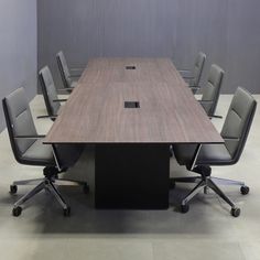 an empty conference table with chairs around it