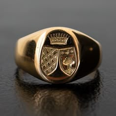 A regal engraving of two crests beneath a crown adorns the signet of this unique vintage ring. Substantial and prestigious, this ring feels both historic and fashion-forward. The thick band tapers in the back for an everyday comfortable fit. Metal: 18k Yellow GoldMeasurements: Width: 12-2mm Size 6.25 in stock Shipping and Delivery: IN STOCK items will ship within 2 business days Sizes not In Stock will be Resized Resize Fee may apply Please allow 2 weeks for delivery All Resize items are final s Classic Oval Signet Ring With Coat Of Arms, Heirloom Oval Signet Ring With Coat Of Arms, Classic Coat Of Arms Ring, Formal Gold Signet Ring With Coat Of Arms, Classic Signet Ring With Coat Of Arms For Anniversary, Classic Ceremonial Signet Ring With Polished Finish, Classic Hallmarked Signet Ring For Collectors, Classic Hallmarked Signet Ring Collectible, Classic Yellow Gold Engraved Ring With Coat Of Arms