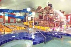 an indoor water park with slides and swimming pool