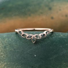 a rose gold wedding band with pear shaped diamonds