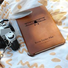 a camera and a book on a bed