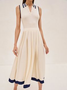 The Ciele Midi Dress is a perfect blend of elegance and comfort. Its collar and button detail give a subtle nod to classic style, while the ivory flows into a pleated midi skirt trimmed with a broad, marine blue hem that adds just the right amount of contrast. It's a versatile piece that works for both office settings and weekend brunches. Pair it with sandals for a relaxed yet sophisticated look. Petite Feminine Fashion, Sunday Best Outfit Church, Blue Runway Dress, Classic Dress Elegant, Office Supply Closet, Tuckernuck Style, Work Midi Dress, 70s Cottage, Classic Feminine Style