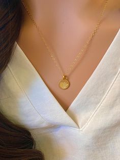 This is a gorgeous Gold Vermeil hand stamped lotus disc necklace. A precious necklace to add to your collection or gift to a friend, mother, or yoga enthusiast. - Pendant - Gold Vermeil  - Chain + Components - 14k Gold Fill - Lobster Clasp - 14k Gold Fill Also available in silver: https://www.etsy.com/listing/182938743/sterling-silver-stamped-lotus-disc Pair this disc necklace with the Itty Bitty Gold Disc necklace: https://www.etsy.com/listing/119133836/itty-bitty-gold-disc-necklace-gold . . . Dainty Round Charm Necklace For Mom, Dainty Round Charm Necklace As Gift For Mom, Dainty Medallion Necklace With Flower Charm, Dainty Heart Pendant Jewelry With Birth Flower, Dainty Medallion Charm Necklace For Gift, Dainty Medallion Jewelry For Mother's Day, Classic Heart Pendant Jewelry With Flower Charm, Delicate Round Heart Charm Jewelry, Spiritual Heart Charm Round Necklace