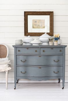 an old dresser is painted blue with white paint