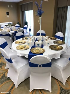 a banquet room set up with blue and white linens