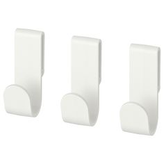 three white wall hooks on a white background