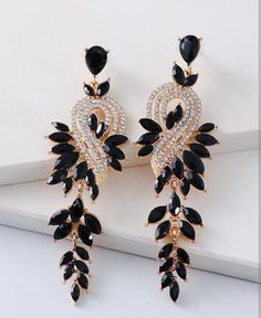 Add sparkle to any look with the DIYA Earrings. Crafted from metal and adorned with rhinestones, these earrings will brighten up any outfit. The perfect accessory for any occasion. Size: 3.77 in x 1.18 in Main Material: Gold Plated | Stainless Steel Stone: Rhinestones Material Type: Alloy Warranty: Hypoallergenic | Safe for Sensitive Skin *Slight natural variations may occur between colors, shapes, sizes of the stones. Black Earrings Aesthetic, Black Earrings Elegant, Concert Earrings, Embellished Fashion, Rhinestone Material, Fancy Earrings, Bold Earrings, Classic Earrings, Vintage Style Jewellery