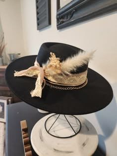 Custom Boho inspired Bolero/ Boater style wide brim  Fedora Black felt with dark taupe chiffon, wide ivory crochet ribbon, natural leather trim, rose gold chain with dried boho flowers. OS fits most, adjustable hat band. Hat has removable bands. These hats come in one size, they have an adjuster inside the crown to cinch them smaller.  We will include two foam reducing tape hat sizers to assist for a proper fit. Exact fit is not guaranteed or implied.  PLEASE make sure you are certain of your purchase before ordering. Because of various sanitary concerns, hats are NOT returnable or exchangeable. Luxury Black Hat Bands For Summer, Bohemian Hats For Spring Parties, Bohemian Style Adjustable Hats For Party, Bohemian Fitted Party Hats, Adjustable Bohemian Party Hat, Elegant Hats For Fall Festival, Elegant Fall Festival Hats, Bohemian Hats For Kentucky Derby Party, Bohemian Brimmed Hat For Parties