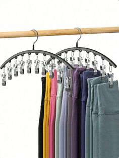 a rack with several pairs of pants hanging from it