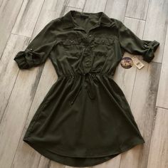 Olive Green Dress. Size Large. Nwt Details: Collar, Button Front, Rolled Button Sleeves Cinched Elastic Waist, Button Front Pockets. Casual Dresses With Roll-up Sleeves For Fall, Khaki Dresses With Buttons For Fall, Green Buttoned Mini Dress For Fall, Green Button-up Mini Dress With Button Closure, Green Mini Dress With Buttons For Fall, Green Mini Dress With Button Closure For Fall, Fall Green Mini Dress With Buttons, Green Buttoned Shirt Dress For Day Out, Green Shirt Dress With Buttons For Day Out